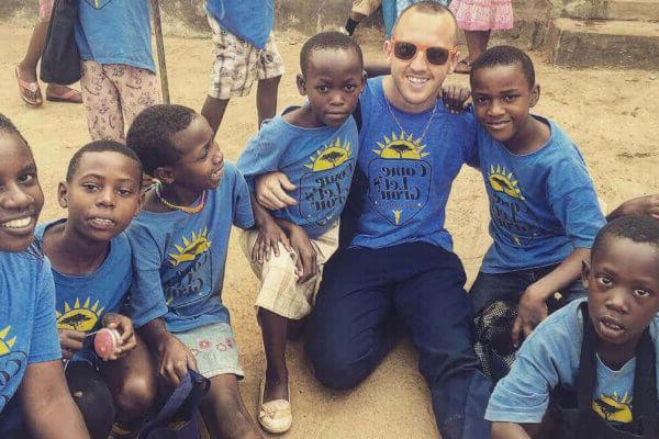 Christopher Ciccarelli ’17 with kids he helped on an overseas trip.